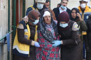 White Helmets volunteers help an injured woman