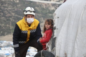 A White Helmets volunteer supporting families in a displacement camp